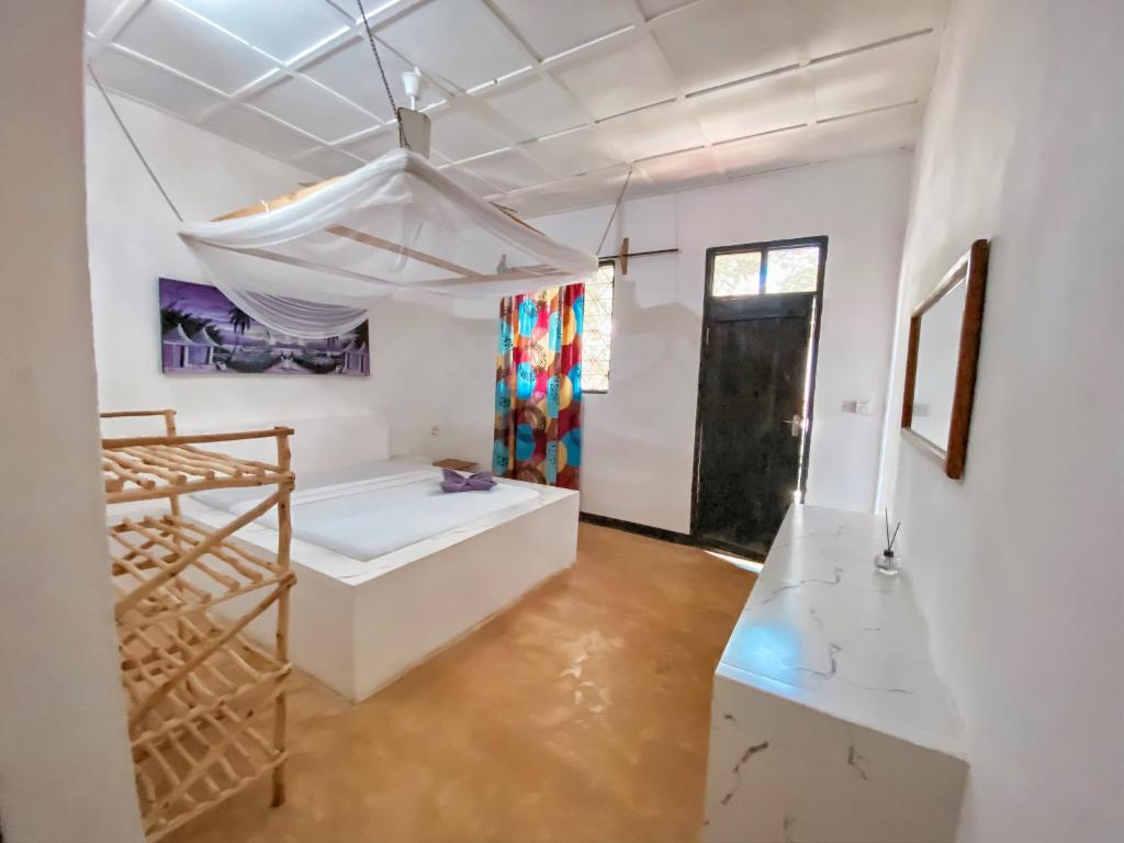 Postel nebo postele na pokoji v ubytování Papaya Guest House Nungwi