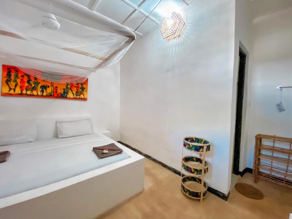 Postel nebo postele na pokoji v ubytování Papaya Guest House Nungwi