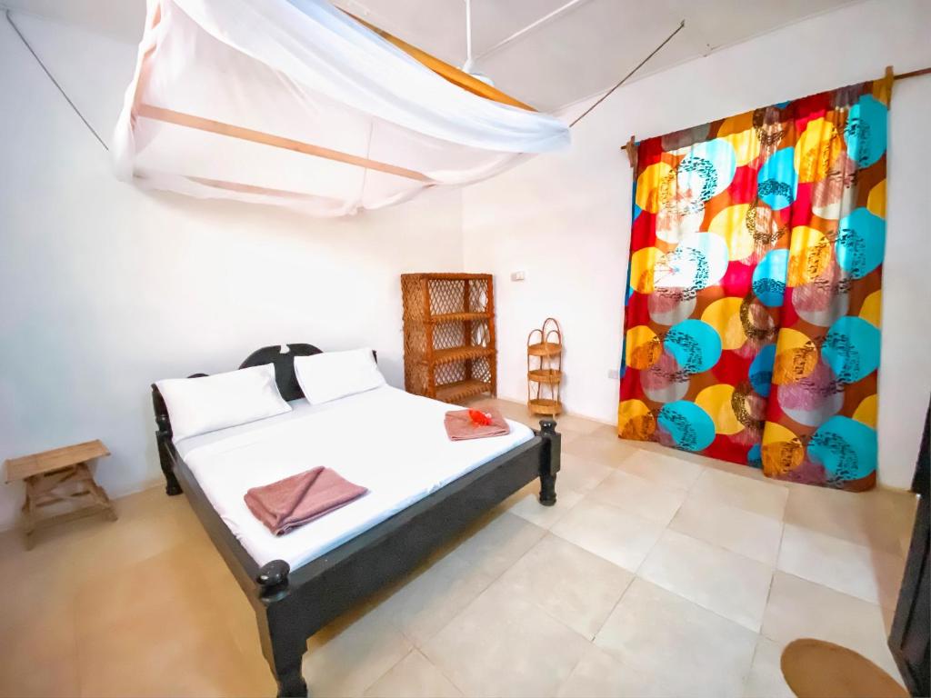 Postel nebo postele na pokoji v ubytování Papaya Guest House Nungwi