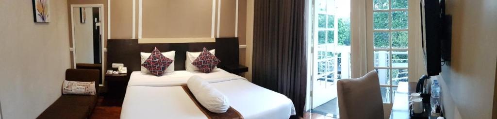 Postel nebo postele na pokoji v ubytování Vio Hotel Cimanuk Bandung