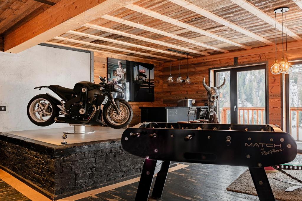 a motorcycle parked on a table in a room at Chalet Carte Blanche Babylon in Tignes