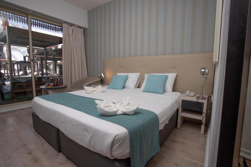 Postel nebo postele na pokoji v ubytování G hotel