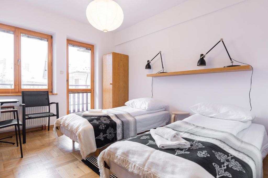 Posteľ alebo postele v izbe v ubytovaní Apartamenty Orkana Centrum Zakopane