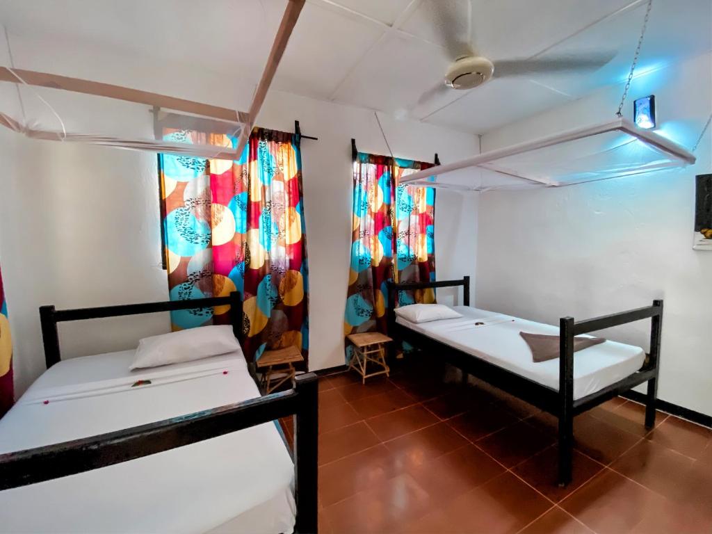 Postel nebo postele na pokoji v ubytování Papaya Guest House Nungwi