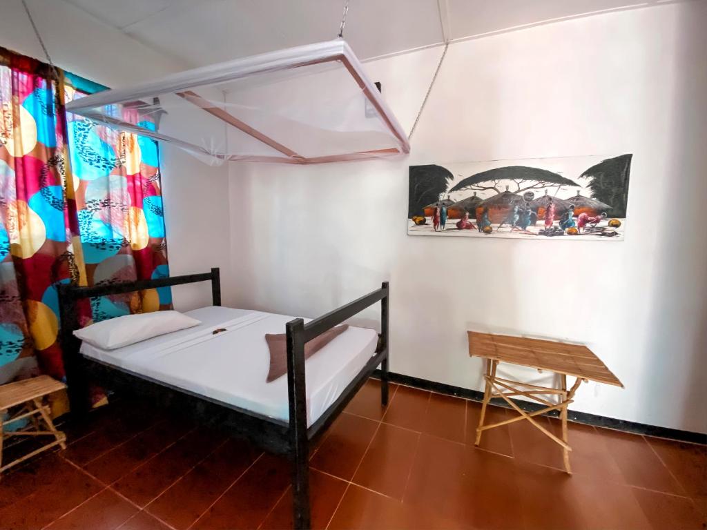 Postel nebo postele na pokoji v ubytování Papaya Guest House Nungwi