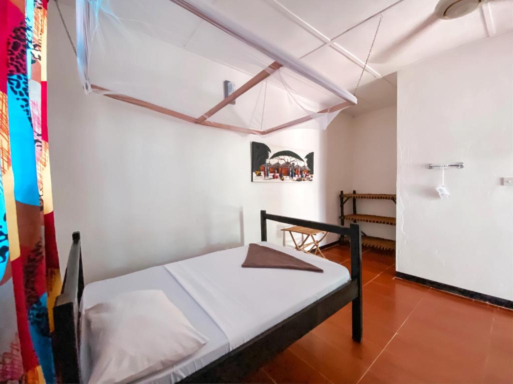 Postel nebo postele na pokoji v ubytování Papaya Guest House Nungwi