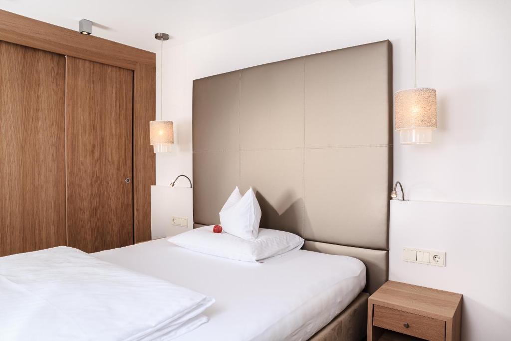 Postel nebo postele na pokoji v ubytování Hotel Trofana Alpin