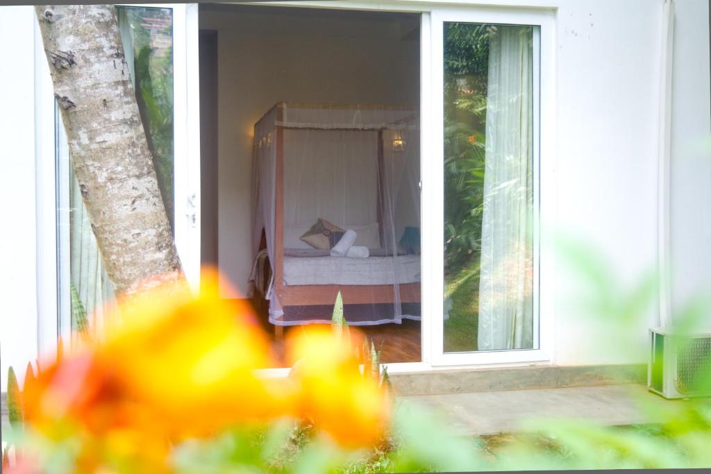 Postel nebo postele na pokoji v ubytování Sweet Cinnamon Kandy