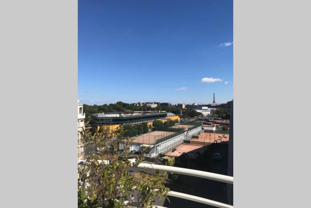 a view of a train station with a train at Bel appartement lumineux / Happy rooftop 120 m2 in Paris