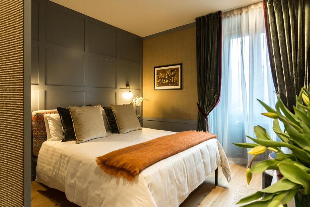 a bedroom with a large bed and a window at Living Suites in Milan