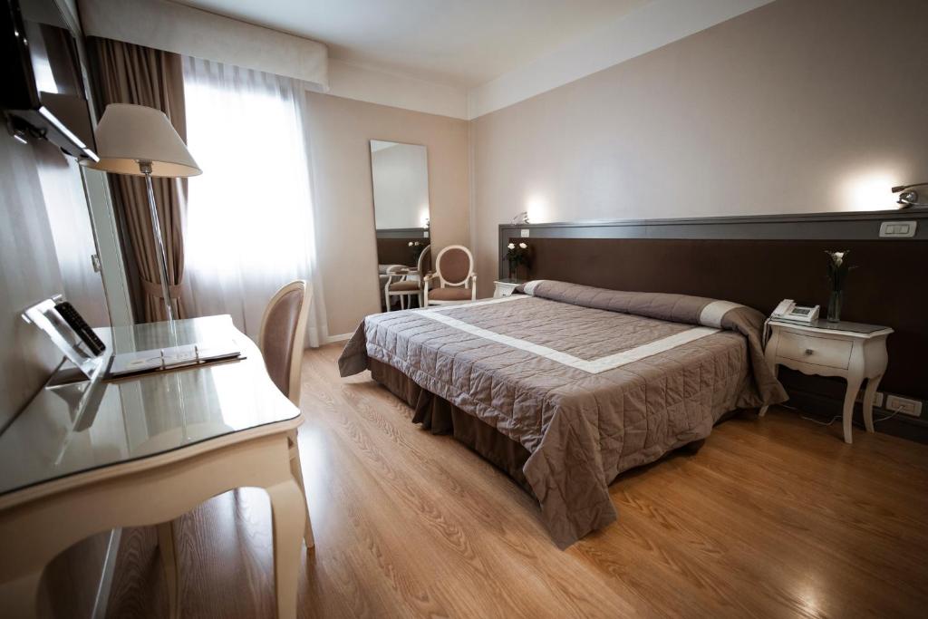 Postel nebo postele na pokoji v ubytování Bonotto Hotel Belvedere