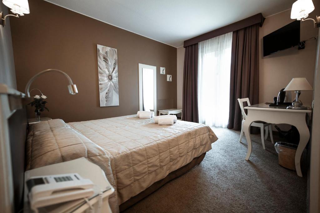 Postel nebo postele na pokoji v ubytování Bonotto Hotel Belvedere