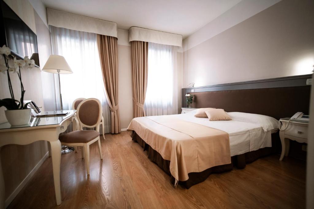 Postel nebo postele na pokoji v ubytování Bonotto Hotel Belvedere