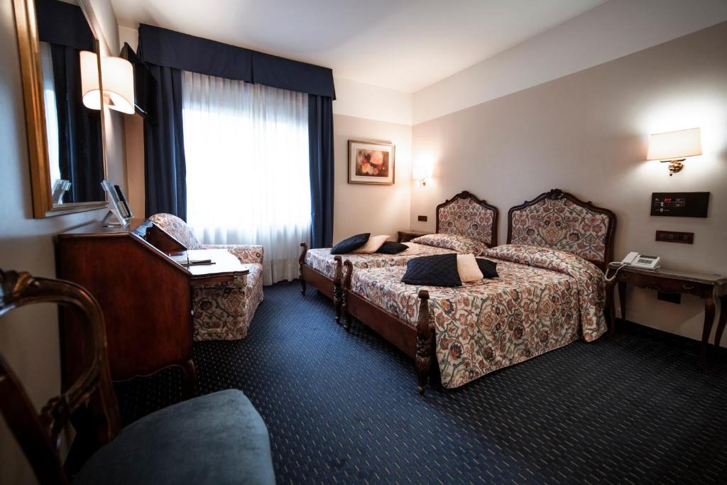 Postel nebo postele na pokoji v ubytování Bonotto Hotel Belvedere