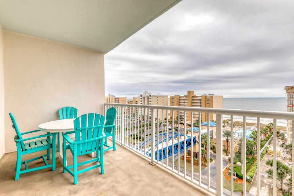 a balcony with a table and chairs and the ocean at Crystal Towers in Gulf Shores