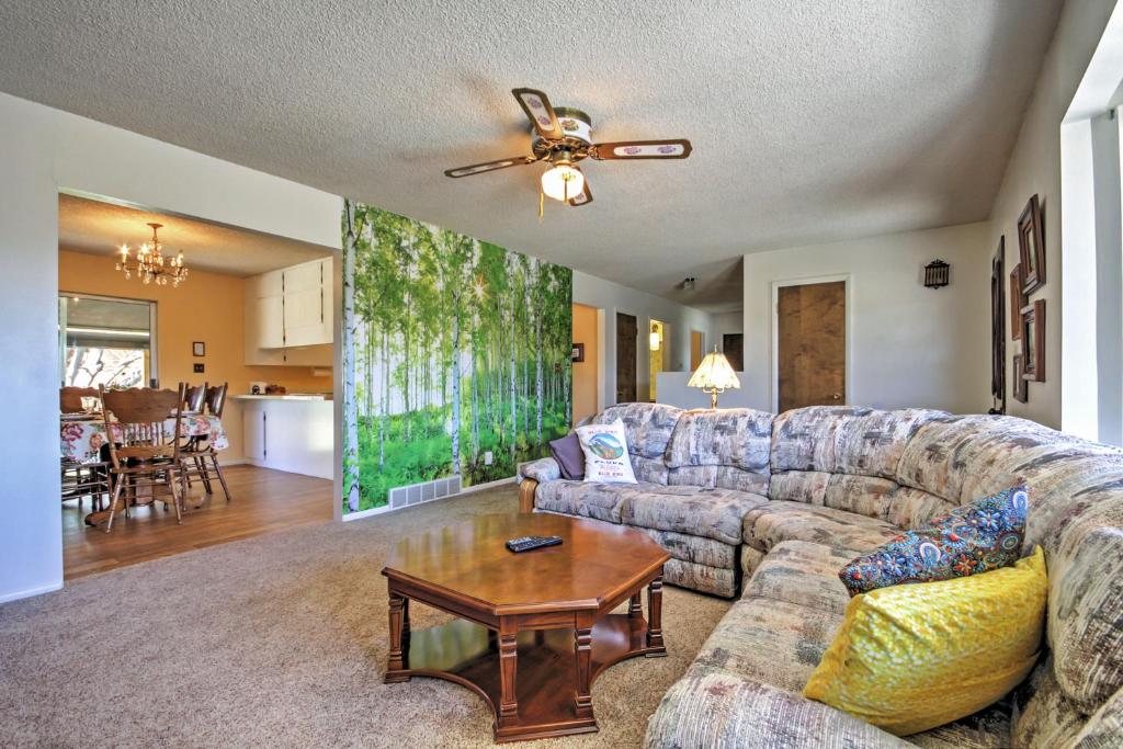 a living room with a couch and a table at Bryce Canyon Area House with Mountain Views! in Tropic