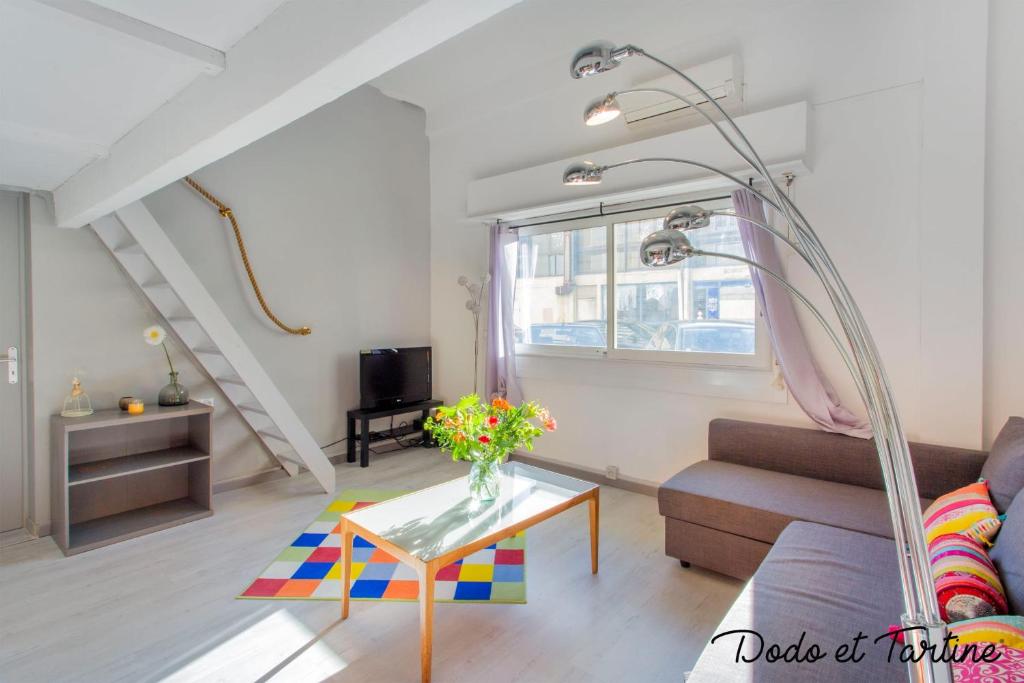 a living room with a couch and a table at Cocooning 1 bedroom with mezzanine - Dodo et Tartine in Toulon