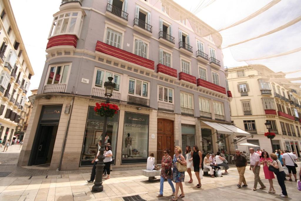 people walking down a street at Apartamentos Calle Larios in Málaga
