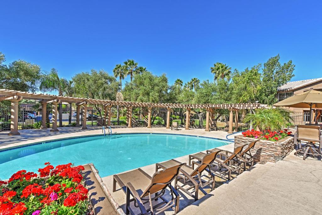 a swimming pool at a resort with chairs and flowers at Resort Retreat in Paradise Valley and Kierland Area! in Scottsdale
