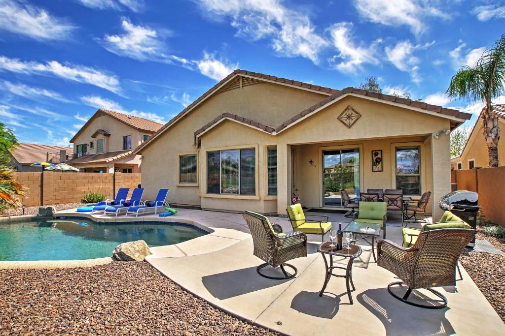 a backyard with a pool and chairs and a house at Queen Creek Home Private Pool and Golf Course View! in Queen Creek