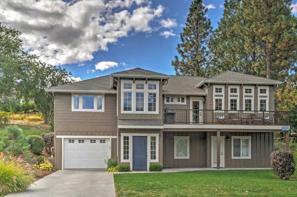 a large house with a garage at Gorgeous Wapato Point Lakehouse with Private Hot Tub in Manson
