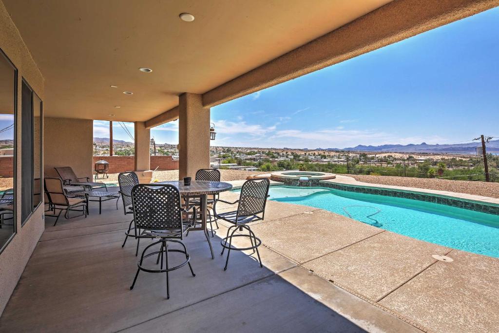 a patio with a table and chairs next to a swimming pool at Lake Havasu City Retreat with Views and Private Pool! in Lake Havasu City