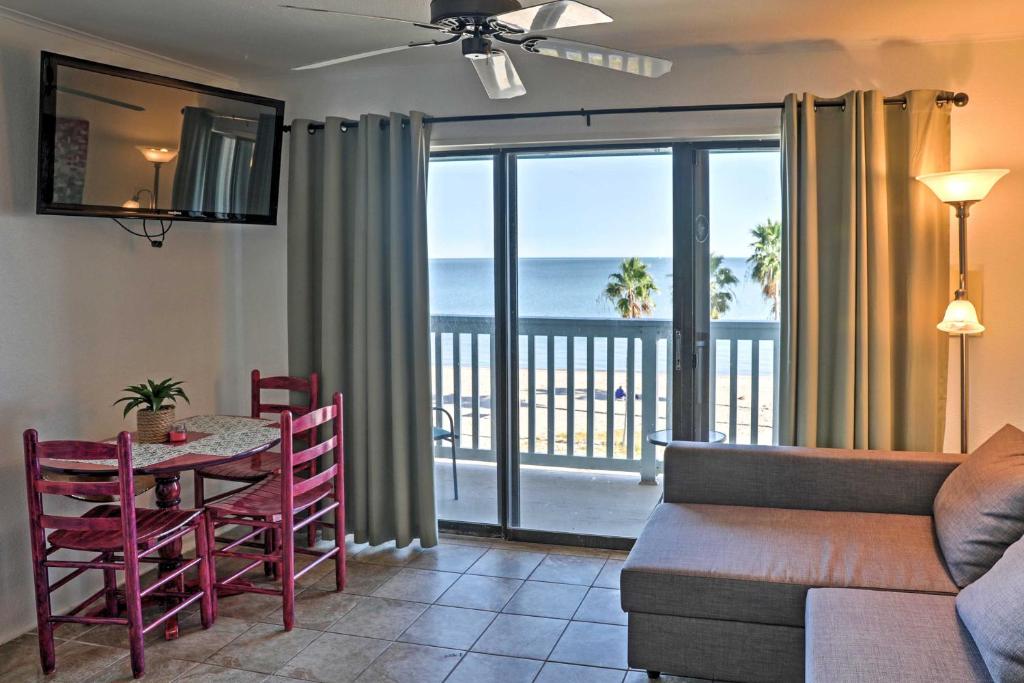 a living room with a table and chairs and a couch at Surfside Sandcastle Suite with Balcony and 2 Pools! in Corpus Christi