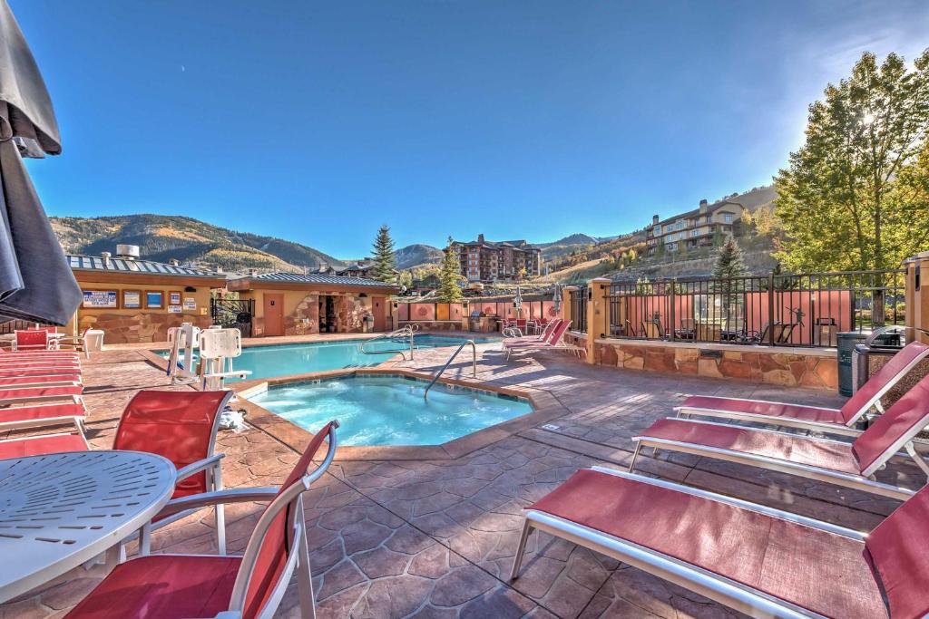 a swimming pool with chairs and a table at Ski-InandSki-Out Studio at Sundial Lodge with Hot Tub! in Park City