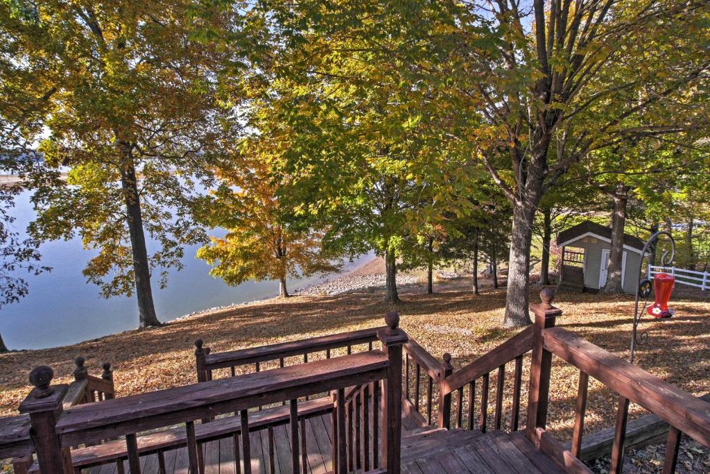 a wooden staircase leading up to a park with trees at Captivating Cadiz Hideaway with Deck on Lake Barkley in Cadiz