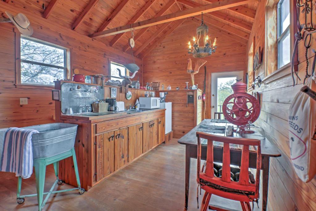 a kitchen with wooden walls and a wooden floor at Ark Bunkhouse Fredericksburg Hideaway with Hot Tub in Fredericksburg