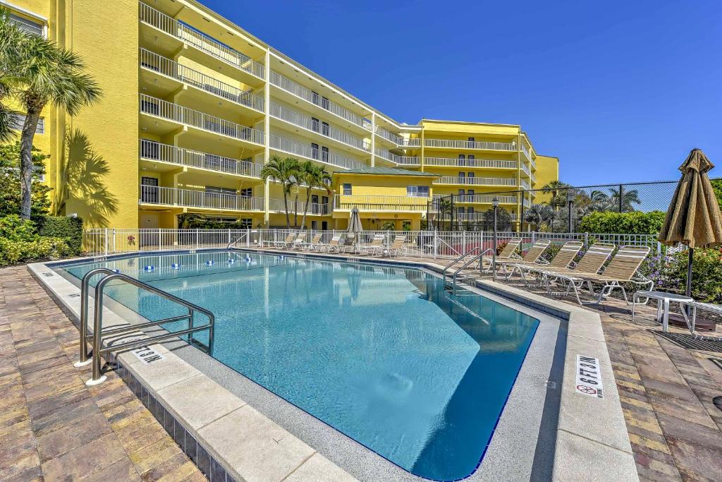a large swimming pool in front of a building at Marco Island Condo with Patio Steps to Beach Access in Marco Island
