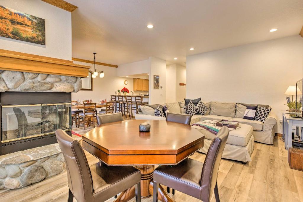 a living room with a table and a fireplace at Deck with Forest Views Incline Village Townhome in Incline Village