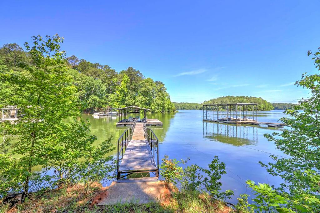 a dock on a lake with boats on it at Waterfront West Point Lake Cabin with Private Dock! in Whitewater Woods