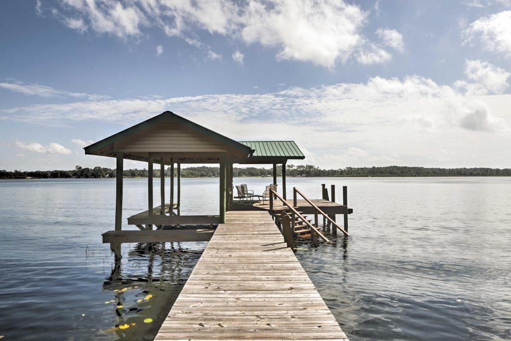 a wooden dock with a gazebo on the water at Lake Broward Cabin with Private Boat Launch and Dock! in Satsuma