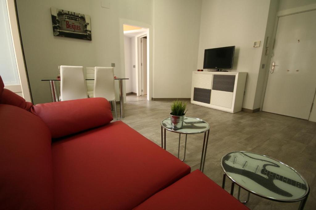 Televízia a/alebo spoločenská miestnosť v ubytovaní Apartamentos Calle Larios