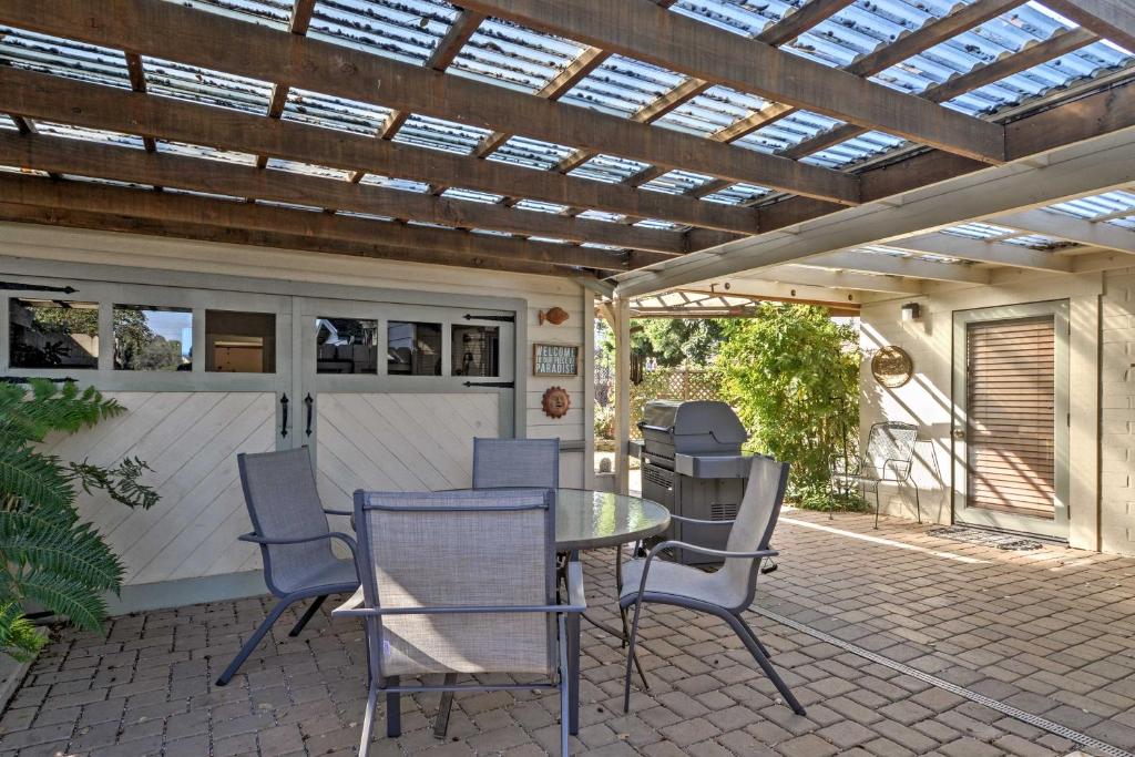 a patio with a table and chairs under a pergola at Cozy Arroyo Grande Cottage with Patio and Grill! in Arroyo Grande
