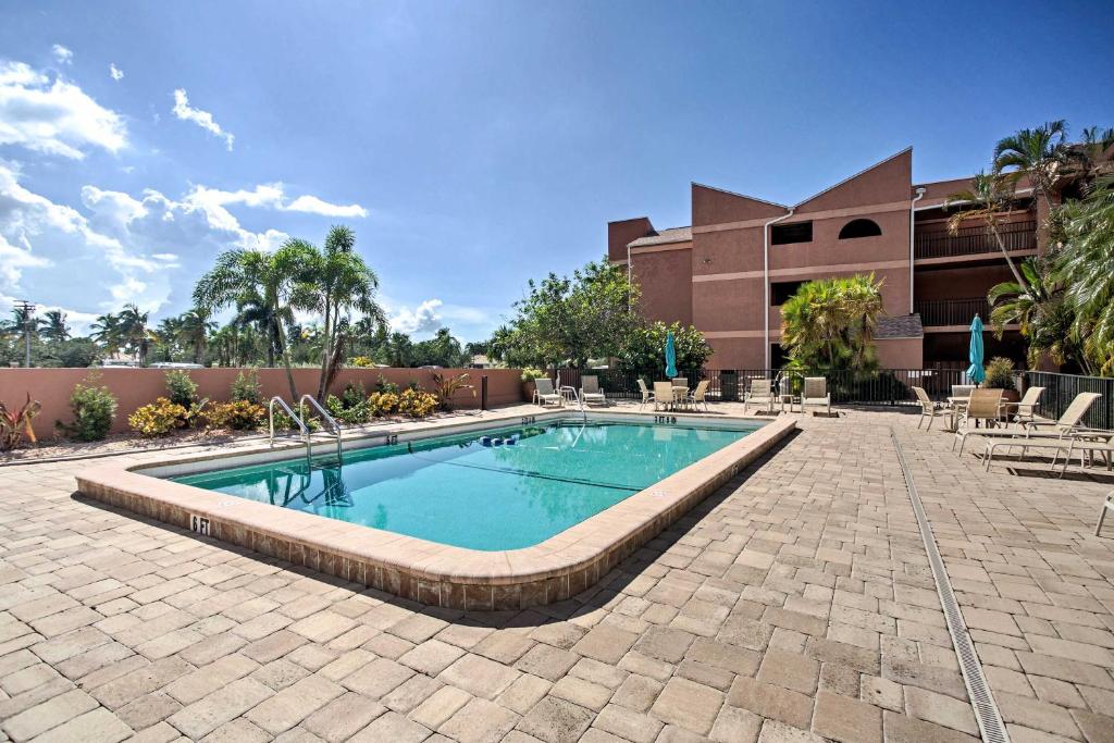 a swimming pool in front of a building at Resort-Style Condo with Pool 19 Miles to Fort Myers in Burnt Store Marina