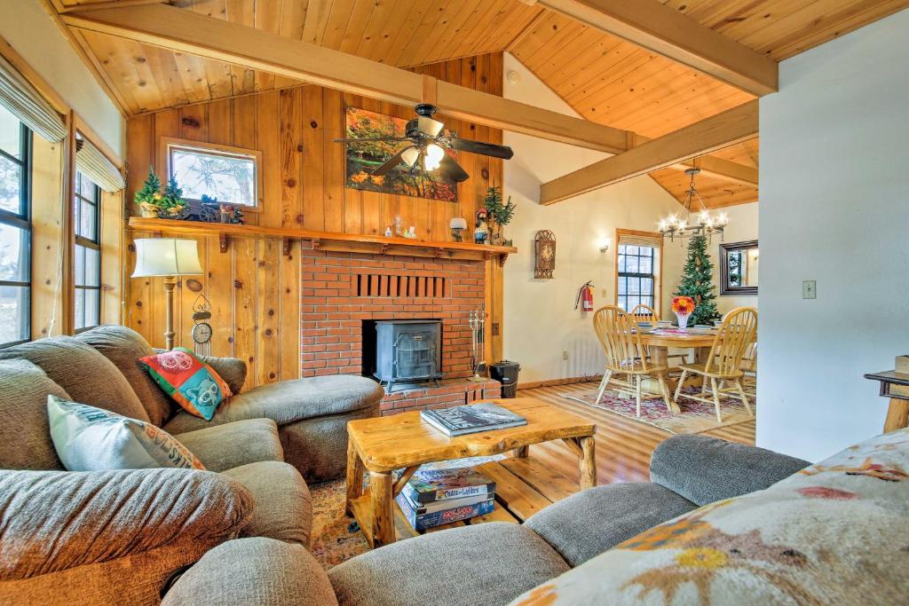 a living room with a couch and a fireplace at Hot Tub and Deck Big Bear Gem Near Resorts! in Big Bear Lake