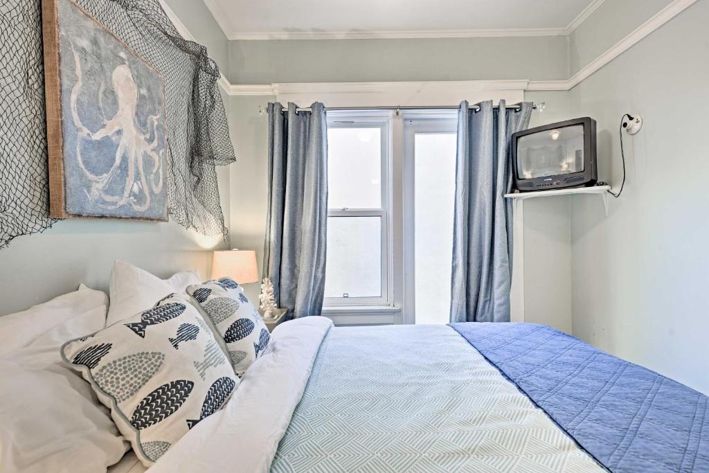 a bedroom with a bed and a tv and a window at Sunny Catalina Island Home - Steps to Avalon Bay! in Avalon