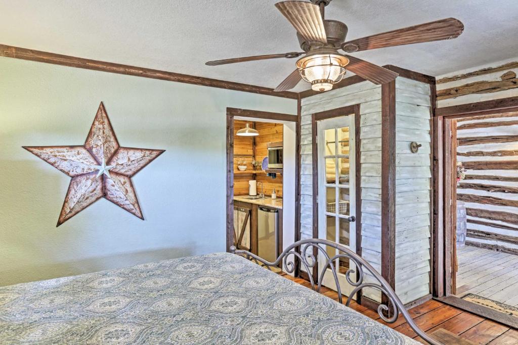a bedroom with a bed with a star on the wall at Gruene Cabin - Pet Friendly New Braunfels Studio in New Braunfels