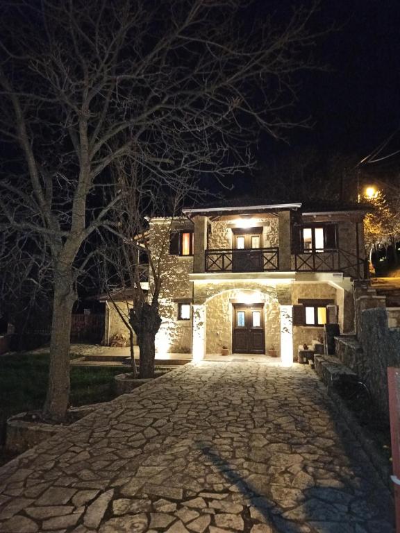 a stone house with a driveway at night at AELIA HOME in Synikia Mesi Trikalon