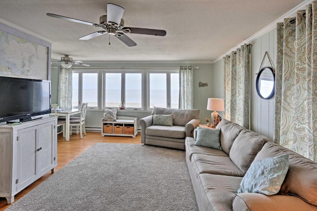 a living room with a couch and a flat screen tv at Waterfront Oak Harbor Home on Lake Erie with Views! in Sand Beach