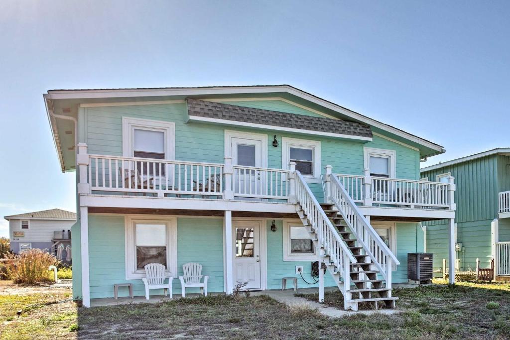 a green house with a white deck and stairs at Holden Beach Vacation Rental Steps to Shore! in Holden Beach