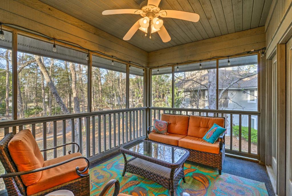 a screened in porch with a couch and a table at Resort Condo with Porch 1 Mi to North Myrtle Beach! in North Myrtle Beach