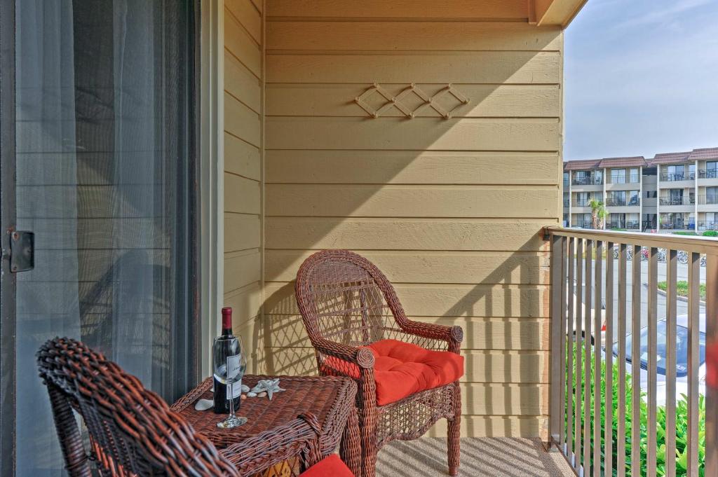a porch with two chairs and a table with a bottle of wine at Hilton Head Resort Condo with Pool and Beach Access in Hilton Head Island
