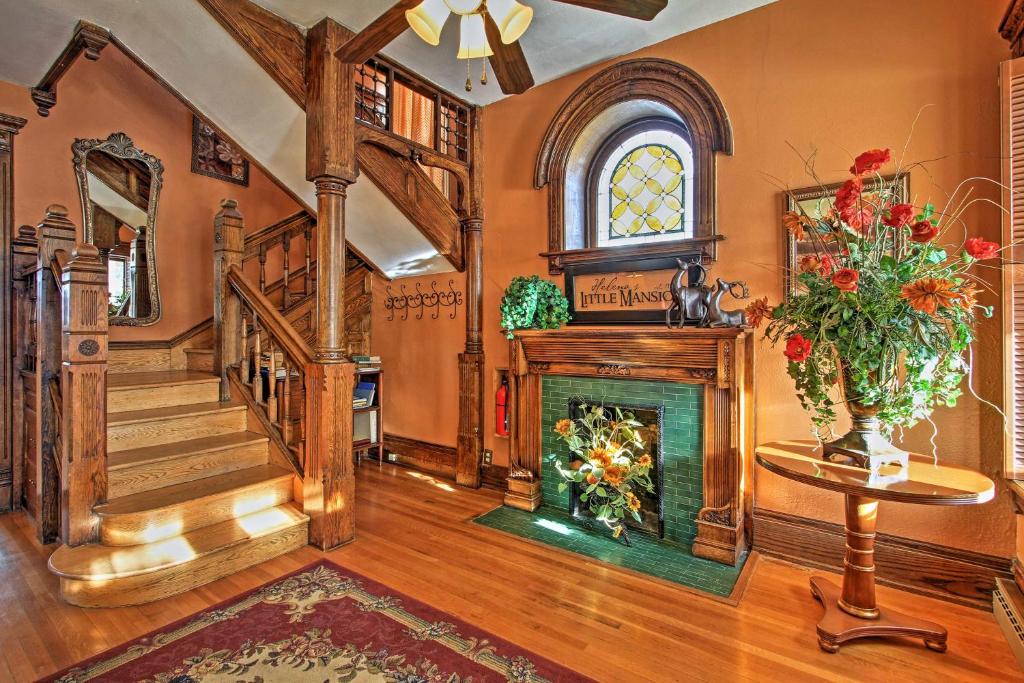 a living room with a fireplace and a staircase at Historic Helena Home with Mtn Views - 2 Mi to Dtwn! in Helena