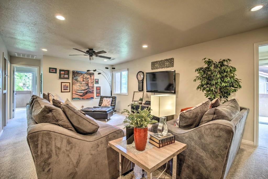 a living room with couches and a tv at Lovely St George Condo with Resort-Style Amenities! in St. George
