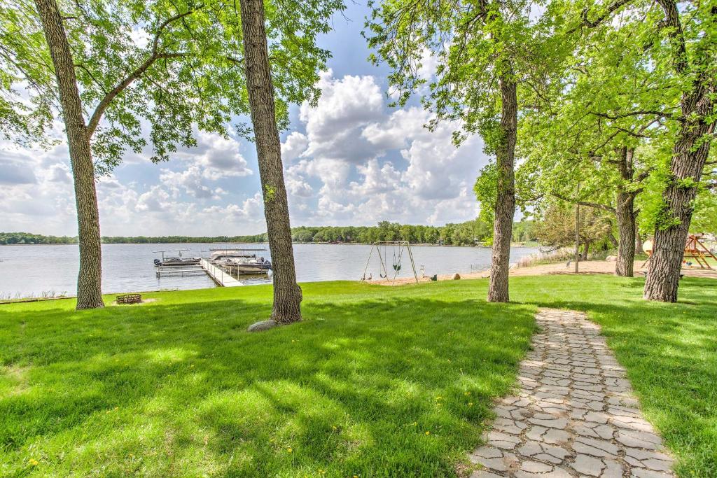 a path in a park next to a body of water at Clearwater Lake Getaway with Shared Pool and Boat Dock in Annandale