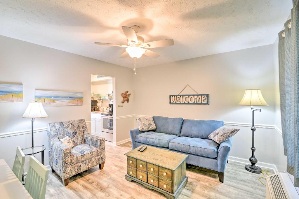 a living room with a couch and a chair at Garden City Condo with Pool Access - Walk to Beach! in Myrtle Beach