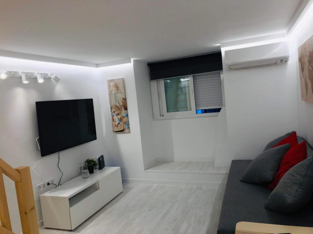 A television and/or entertainment centre at Cozy Apartment Malasaña FREE Parking